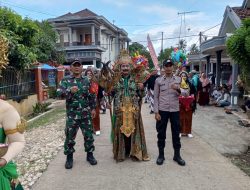 Serda Istiono Anggota Koramil 0818/13 Kalipare Amankan Kirab Budaya dalam Rangka Bersih Desa di Putukrejo