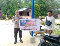 Dengan mengunakan Banner, Bripka Riswantoro Ajak Warga tidak Melakukan Pembakaran Hutan dan Lahan