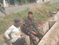 Jaga Pasokan Air Sawah, Babinsa Koramil 23/Nisam Turun Ke Areal Irigasi Bersama Petani