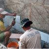 Pemasangan Dinding Keramik, Personel Satgas TMMD Percepat Pembangunan MCK di Wanam Merauke