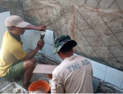 Pemasangan Dinding Keramik, Personel Satgas TMMD Percepat Pembangunan MCK di Wanam Merauke